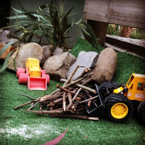 toy trucks and bulldozer playing activity