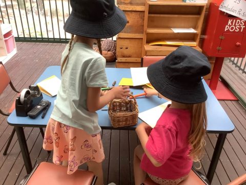 2 children preparing mail for the post box